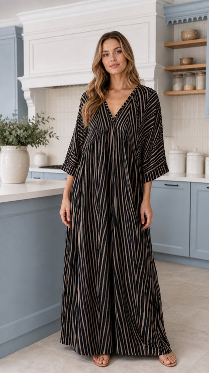 Front view of woman wearing Black and ivory striped wide-leg maxi jumpsuit