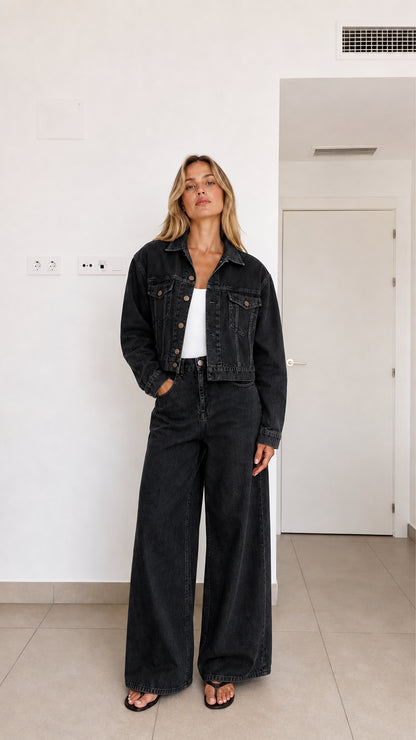 Woman wearing washed black 2-piece cropped denim jacket and wide-leg pants set