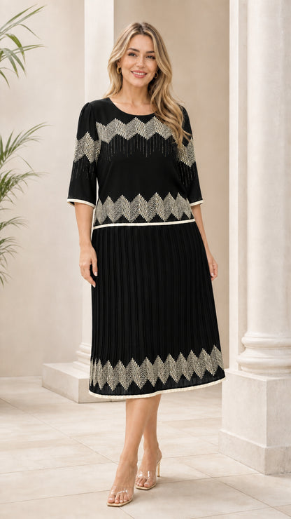 Black geometric pleated midi dress shown from the front