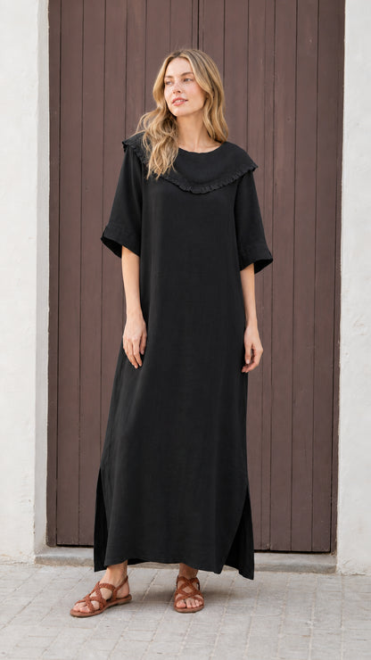 Front view of woman wearing black relaxed-fit maxi dress