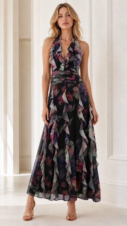 Front view of model wearing black floral halter ruffle maxi dress