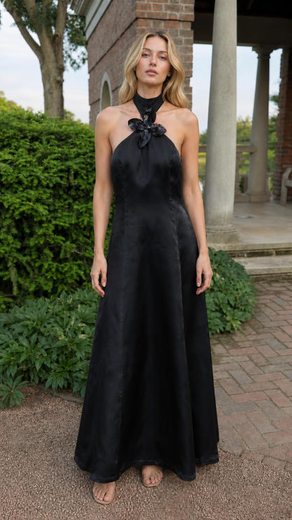 Full front view of model in black satin halter maxi dress