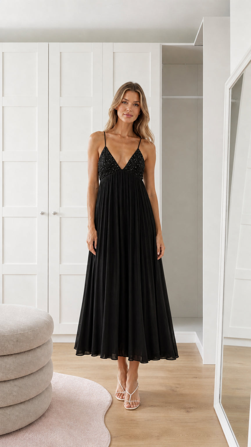 Front view of model wearing black sequin pleated maxi dress
