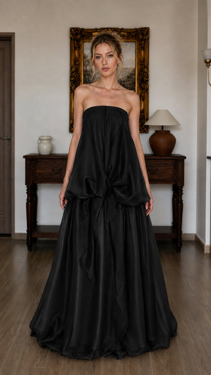 Model wearing black strapless tiered maxi dress