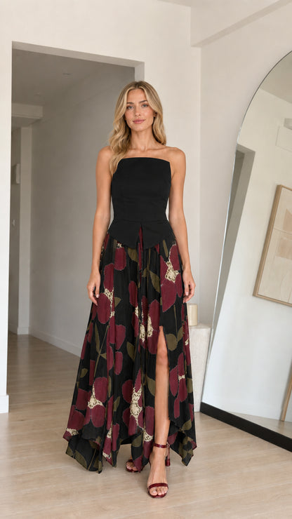 Model wearing black variant of strapless floral maxi dress