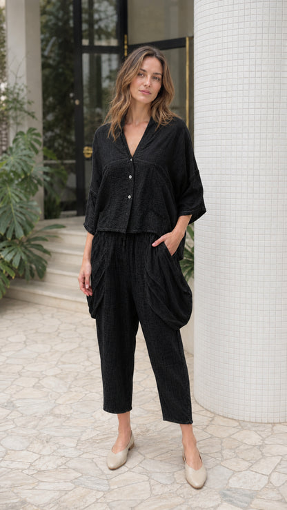 Front view of woman wearing black two-piece lounge set