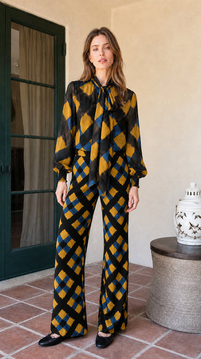 Model wearing black and gold colorway of the plaid matching set