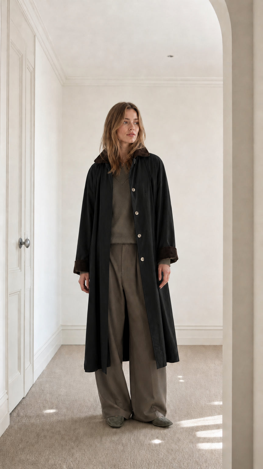 Full front view of model wearing Black long duster coat with contrast collar