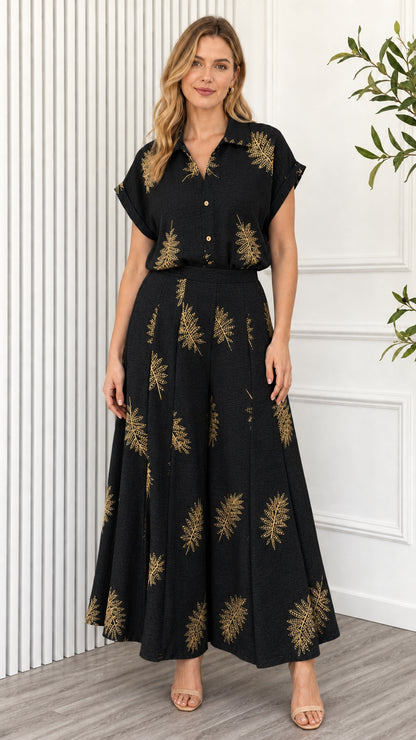 Model wearing black leaf print two piece set