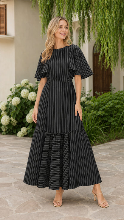 Front view of model wearing black striped flutter sleeve tiered maxi dress