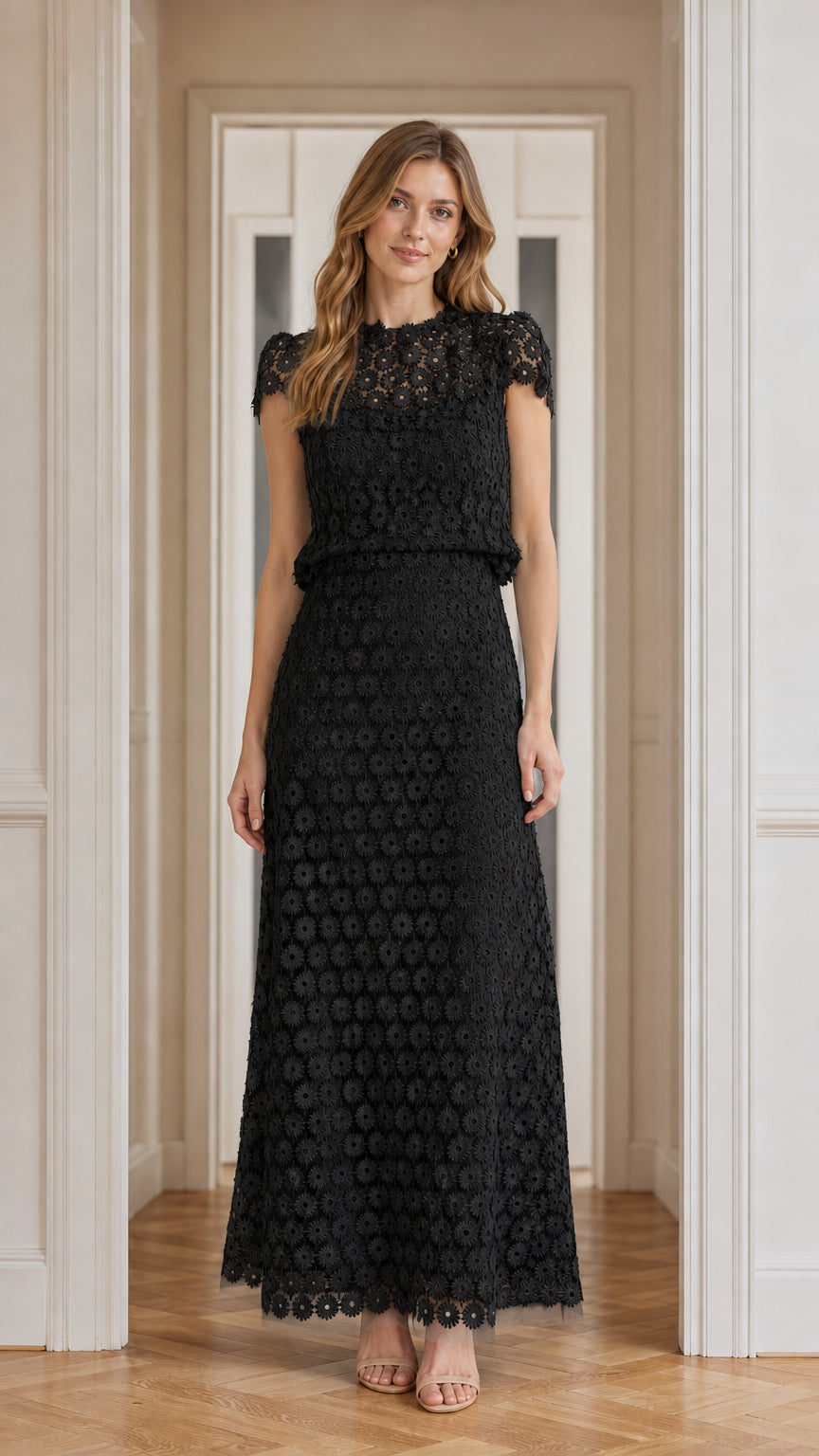 Model wearing black floral lace maxi dress, front view