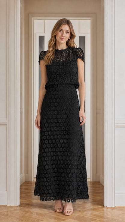 Model wearing black floral lace maxi dress, front view