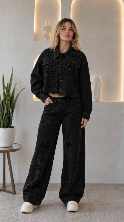 Woman wearing black rhinestone star cropped denim jacket and wide leg jeans two-piece set