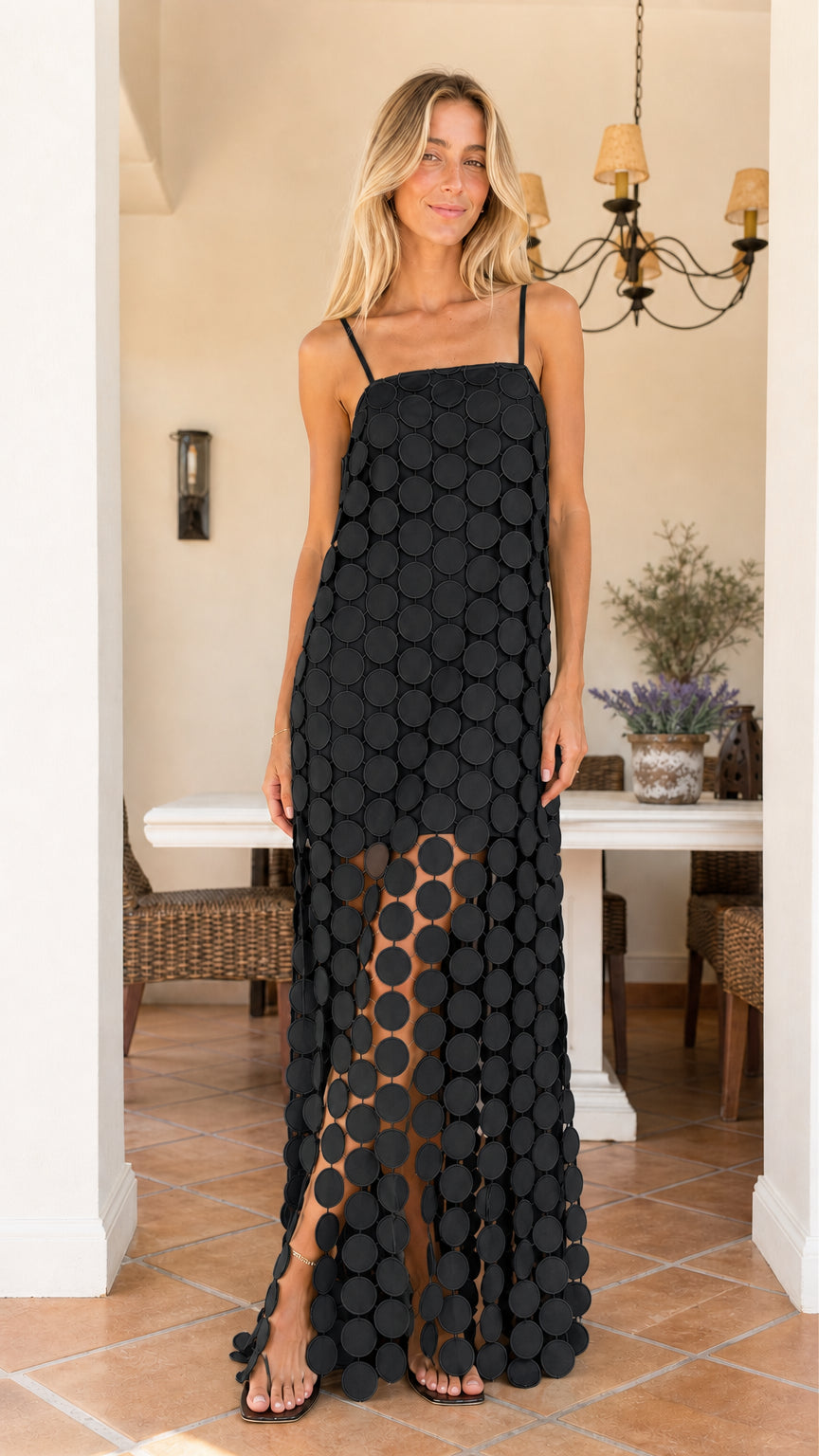 Front view of woman wearing black cutout circle maxi dress