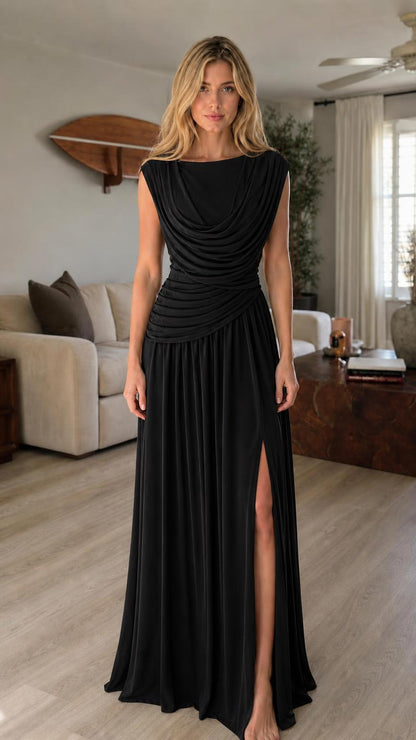 Model wearing black cowl neck maxi dress with high slit