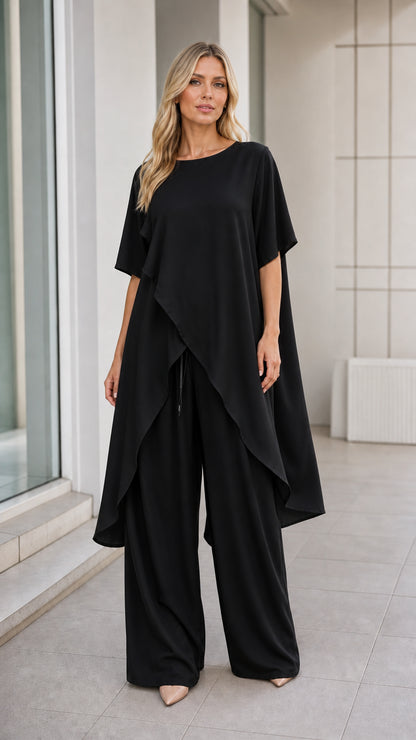 Model wearing black asymmetric tunic and wide-leg pants set