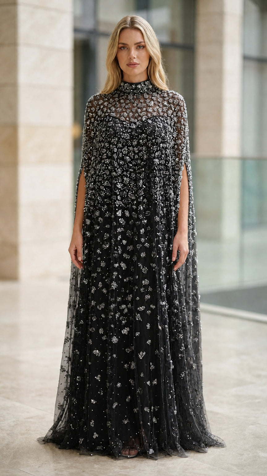Model wearing black sequined beaded high neck cape evening dress