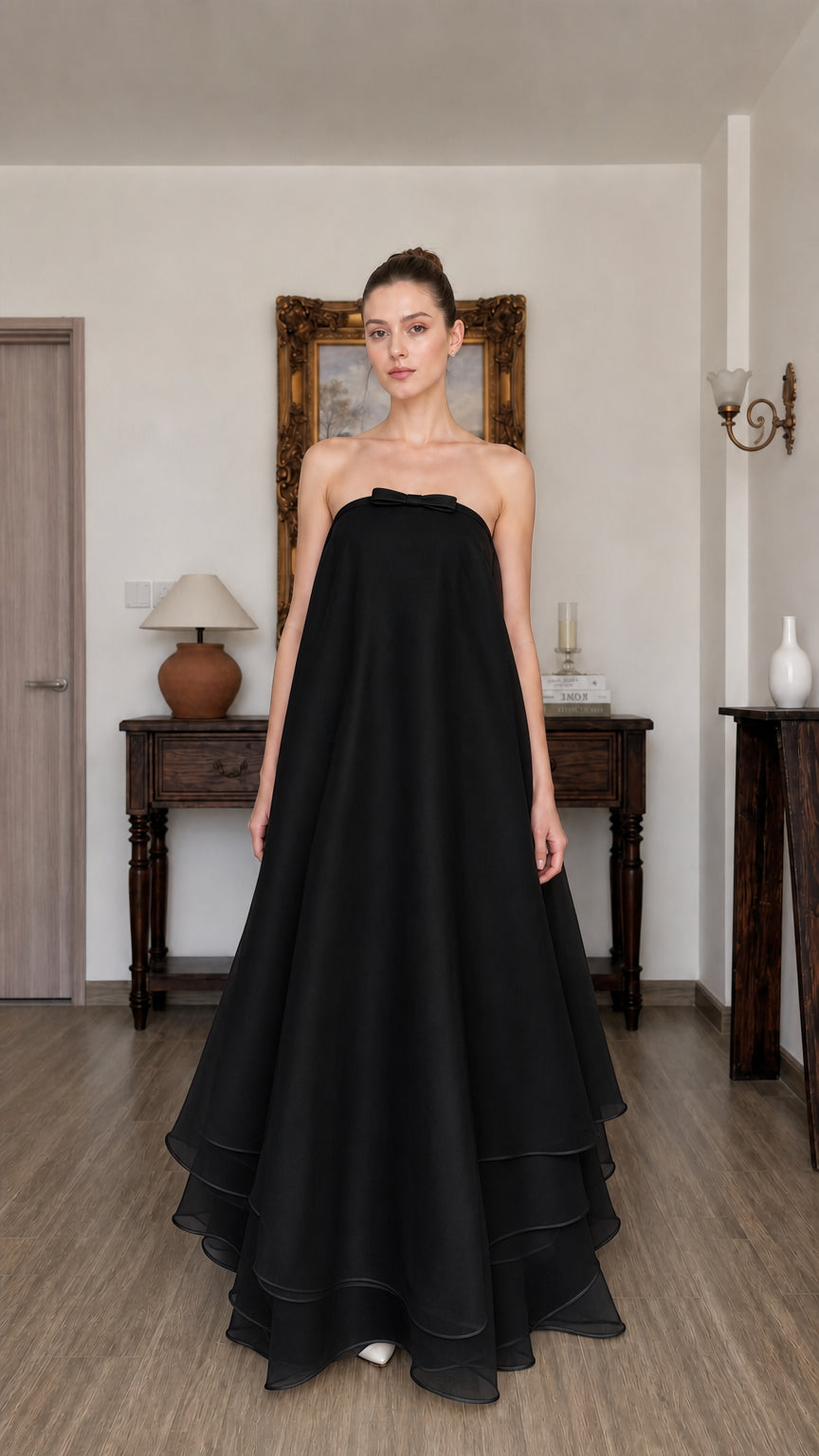Woman wearing black strapless tiered long dress