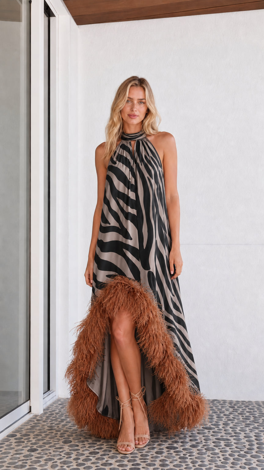 Model wearing black and white zebra print maxi dress with feather hem