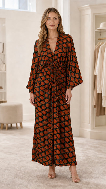 Model wearing black and orange geometric print maxi dress