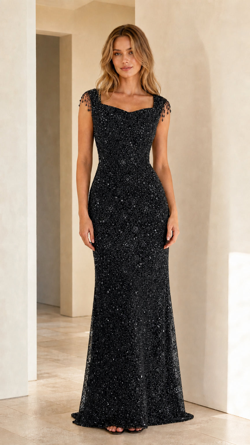 Full-length classic black sequined evening gown with beaded shoulder fringe