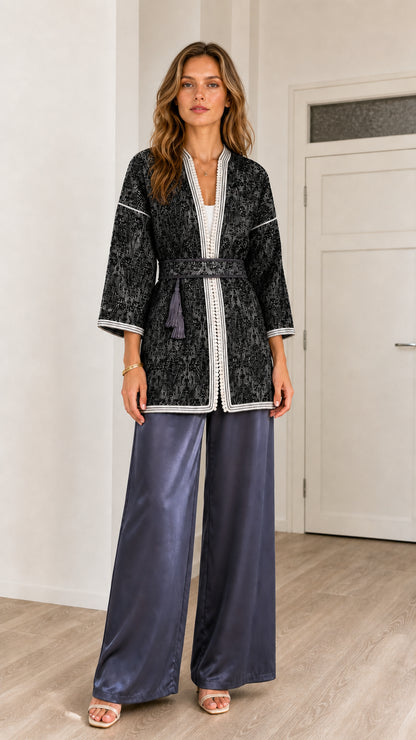 Front view of model wearing Black jacquard belted kimono cardigan with contrast white trim