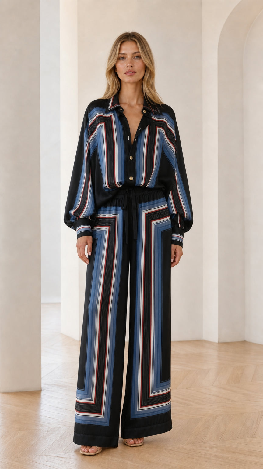Model wearing black geometric striped two-piece set