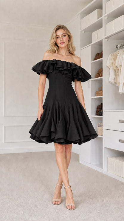 Front view of model wearing black off-shoulder ruffle dress