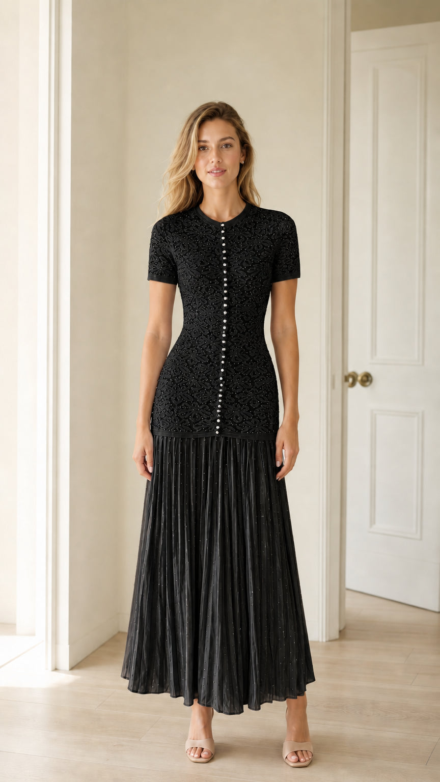 Front view of black pearl button knit bodice pleated midi dress