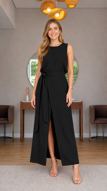 Model wearing black sleeveless belted maxi dress with front slit