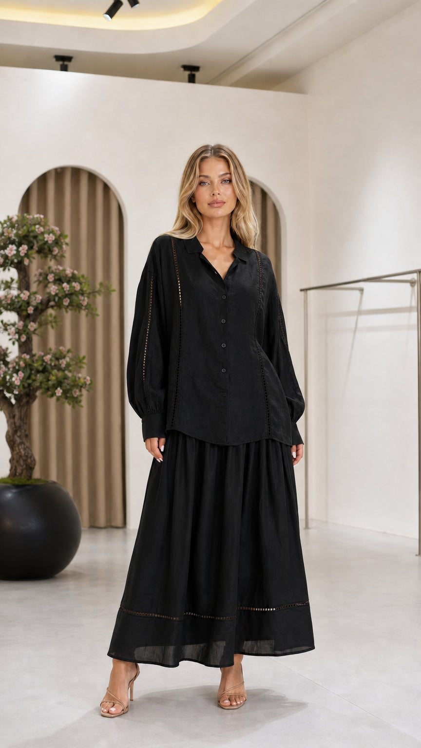 Front view of the black women's blouse and maxi skirt two-piece set