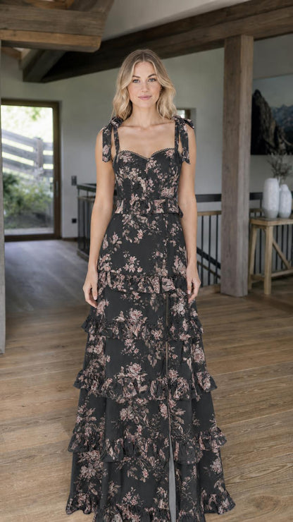 Model wearing black floral print tiered maxi dress