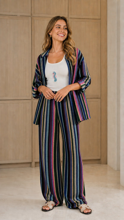 Front view of woman wearing dark multi striped two-piece set