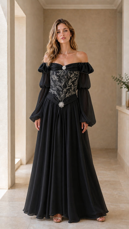 Model wearing black Renaissance maxi dress with silver embroidery and off-shoulder puff sleeves