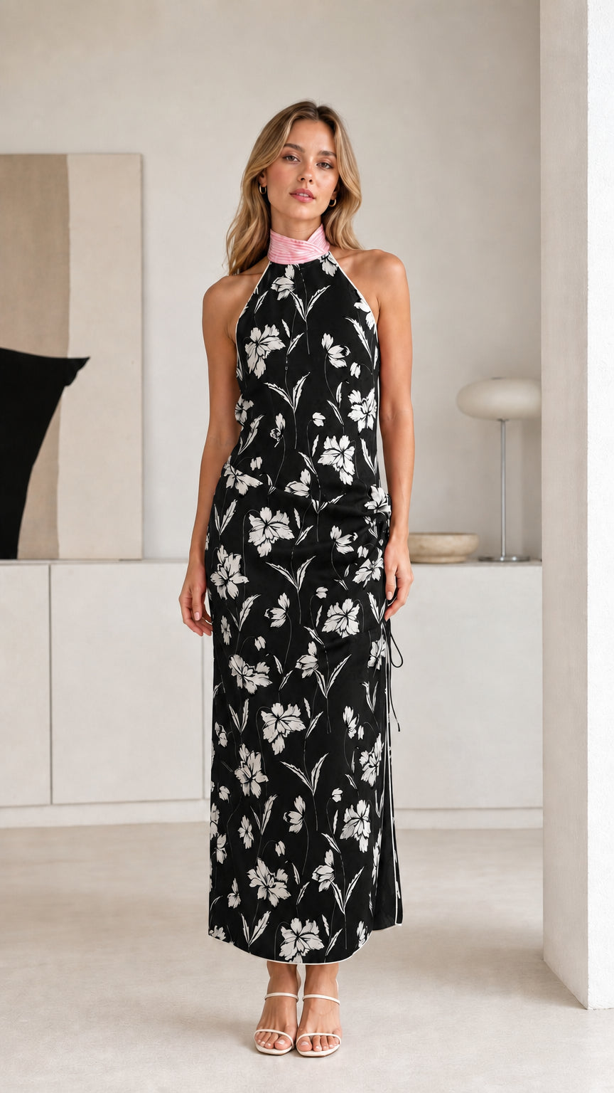 Woman wearing black floral halter maxi dress