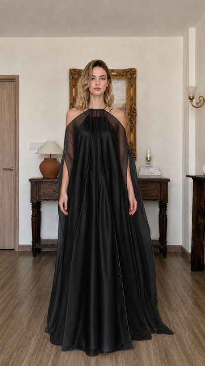 Model wearing black flowy halter maxi dress