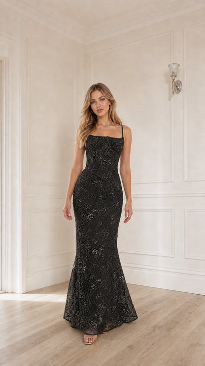 Woman wearing black sequin embroidered corset maxi dress