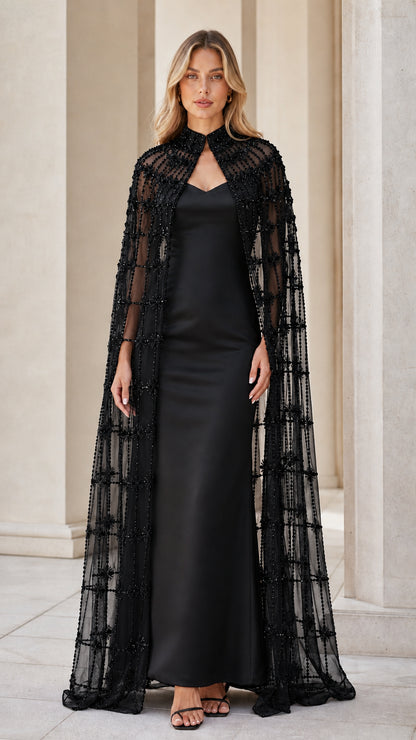 Model wearing black beaded cape and matching evening gown