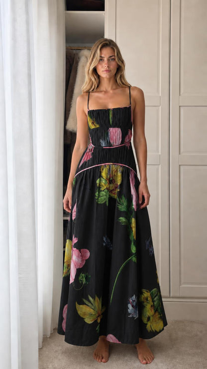 Model wearing black floral print smocked maxi dress