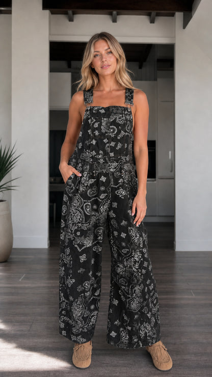 Front view of woman wearing Black paisley print wide-leg overalls