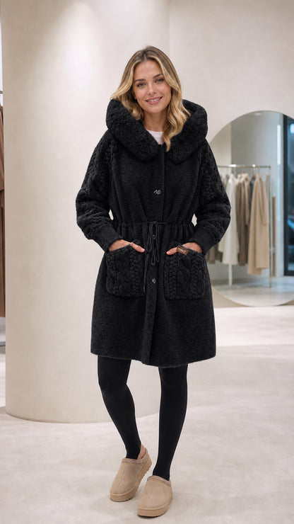 Front full-length view of woman wearing black hooded plush fleece coat