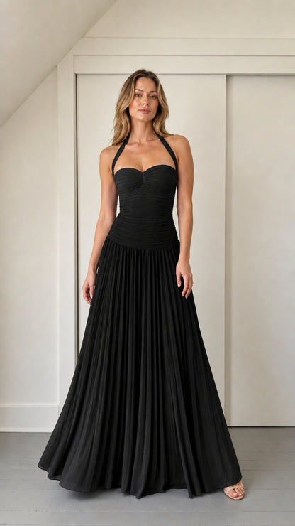 Model wearing solid black ruched halter maxi dress