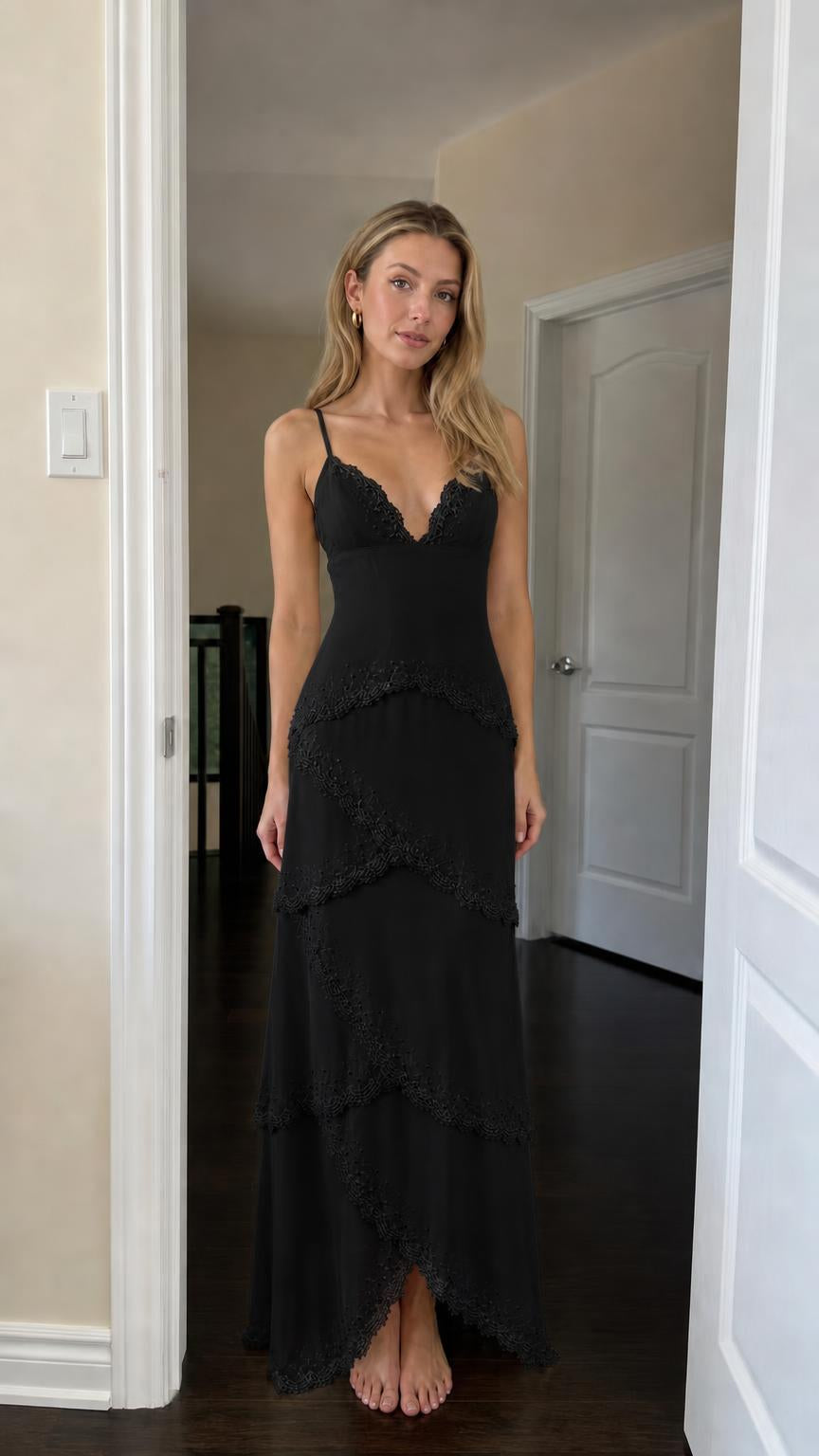 Front view of woman wearing black tiered lace maxi dress