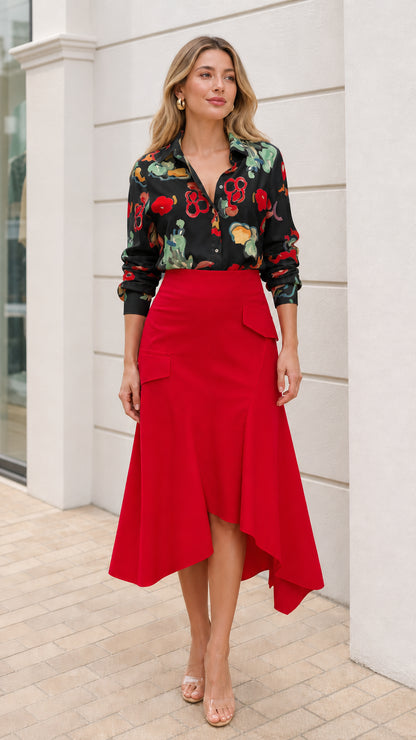 Model wearing black floral button down shirt and red asymmetric midi skirt