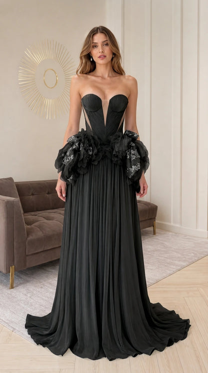Black strapless evening gown with dramatic ruffle waist detail