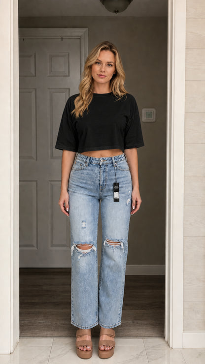 Model wearing black crop top with light wash jeans, front view