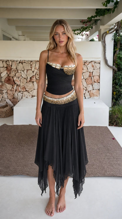 Model wearing black two-piece beaded crop top and skirt set