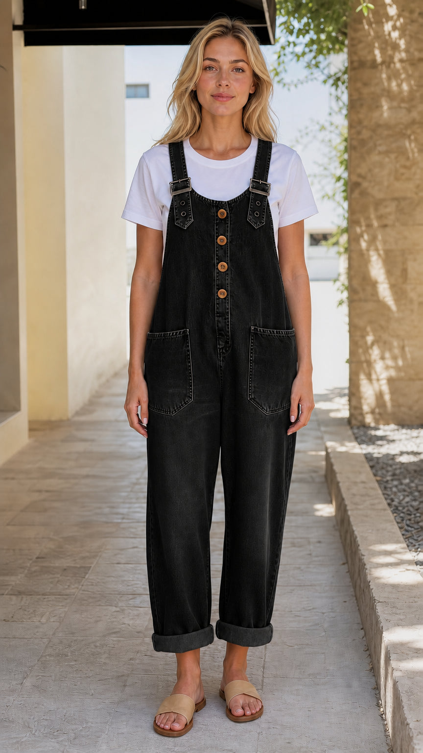 Front view of model wearing black denim overalls