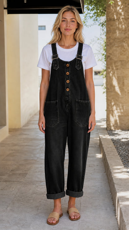 Front view of model wearing black denim overalls
