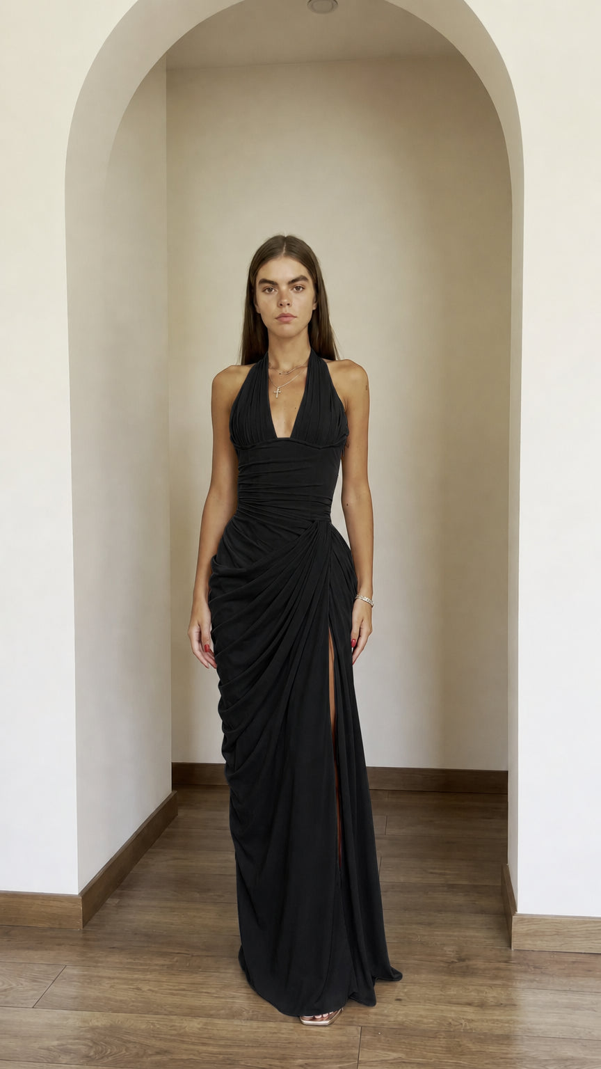 Front view of model wearing black halter ruched maxi dress